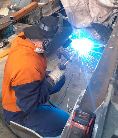 welder working on truck body